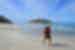 Intrepid traveller with hiking gear takes a barefoot walk along a beach on the Bibbulmun Track