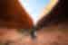 Two travellers pose happily between sweeping stone sides of Kata Tjuta in the Red Centre of Australia