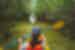 Shot behind Intrepid traveller with paddle kayaking through mangrove forsests in Costa Rica