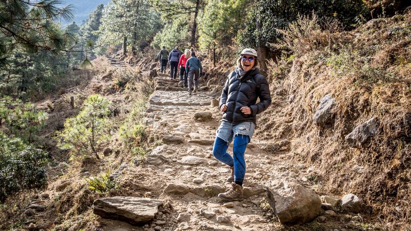 A smiling hiker on a hiking trail in Nepal