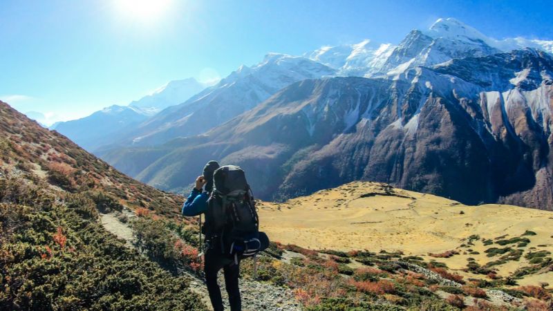 A hiker wearing a backpack on the Annapurna trail