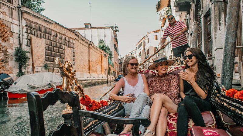Three women on a gondola in Italy