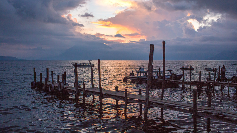 A view of the sunset from a rickety wooden pier on Lake Atitlan.