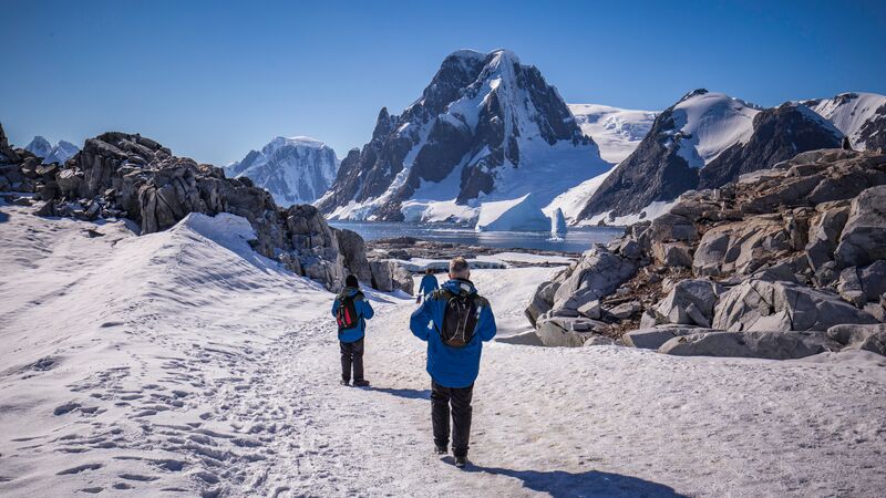 Travellers in trekking through the ice in Antarctica