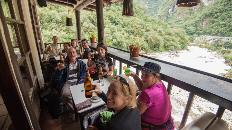 Travellers enjoying a beer after the trek