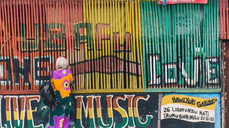 Girl in front of brightly coloured wall in Guatemala