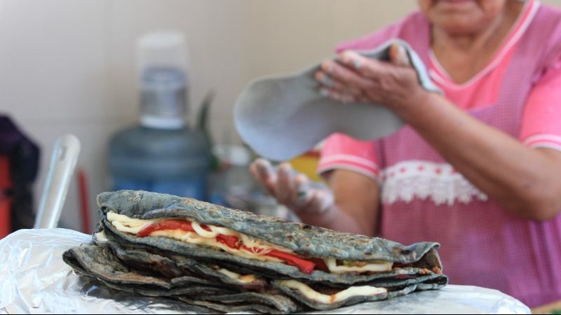 A woman making quesdillas