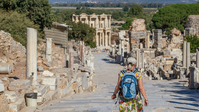 A woman walks towards Turkish ruins