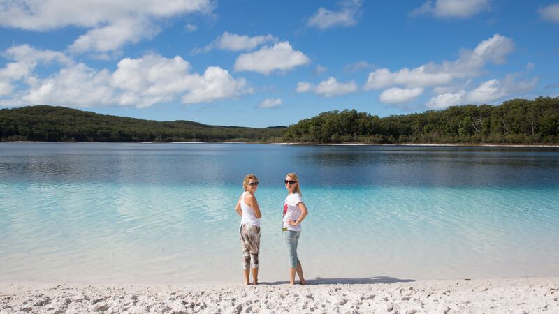 Two women wade in a beautiful bay