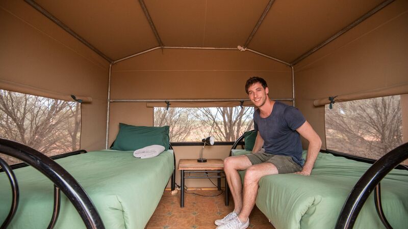 A man sitting in a tent.