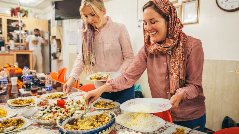 Two women serving food in Iran