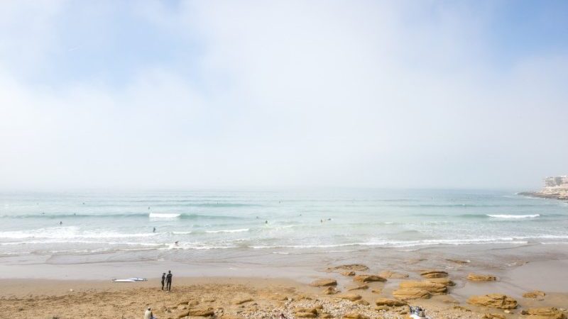 Person an a beach in the distance overlooking the Atlantic ocean.