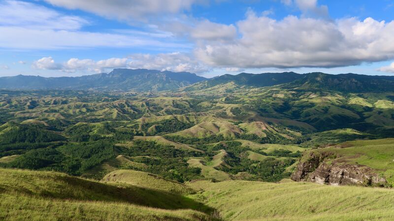 Rolling green hills and blue sky on a Fiji island
