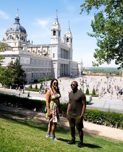 A man and a woman standing in front of a palace in Madrid