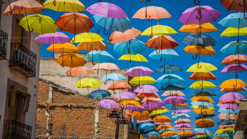 Colourful umbrellas hanging above the street