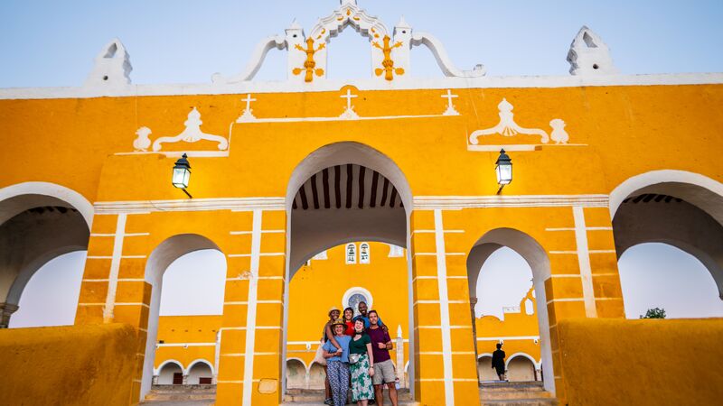 A group of travellers in front on a monastery in Izamal, Mexico