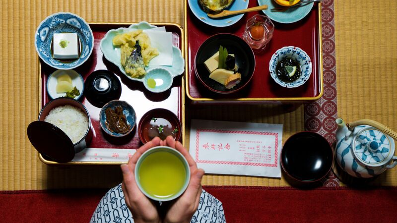 Two trays filled with a traditional Japanese breakfast