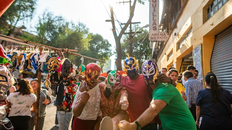 Four travellers wearing wrestling masks