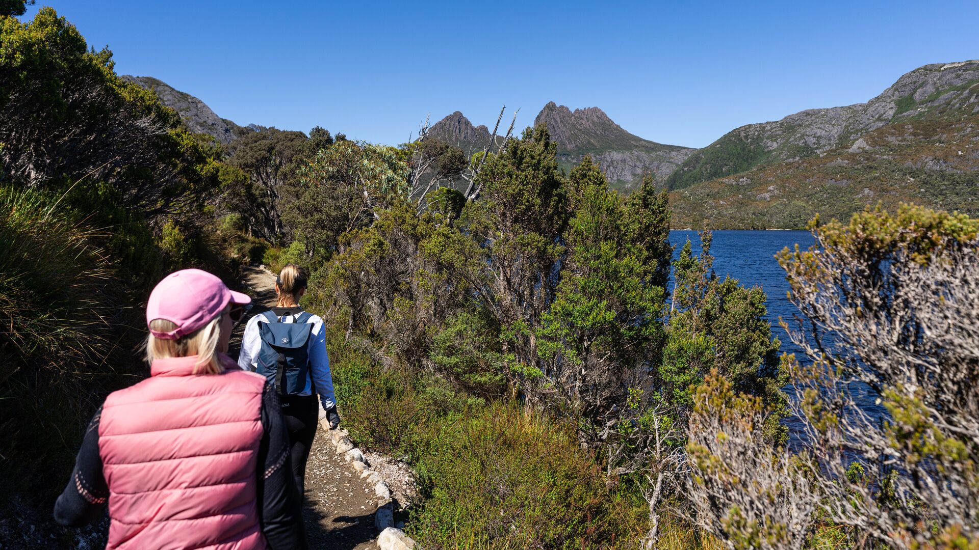 Two travellers hiking around Lake Dove Lake in Cradle Mountain National Park, Tasmania