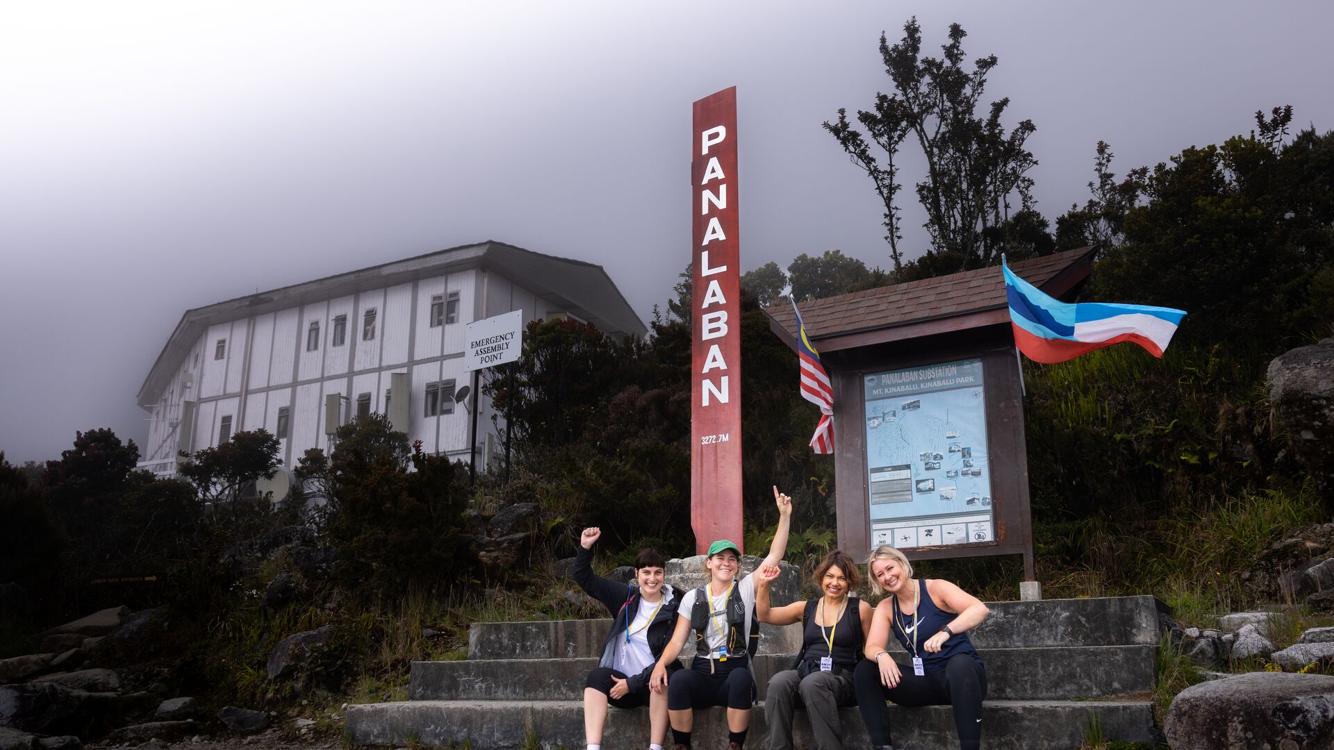 Four hikers smiling after reaching Laban Rata Resthouse on the Mt Kinabalu trek