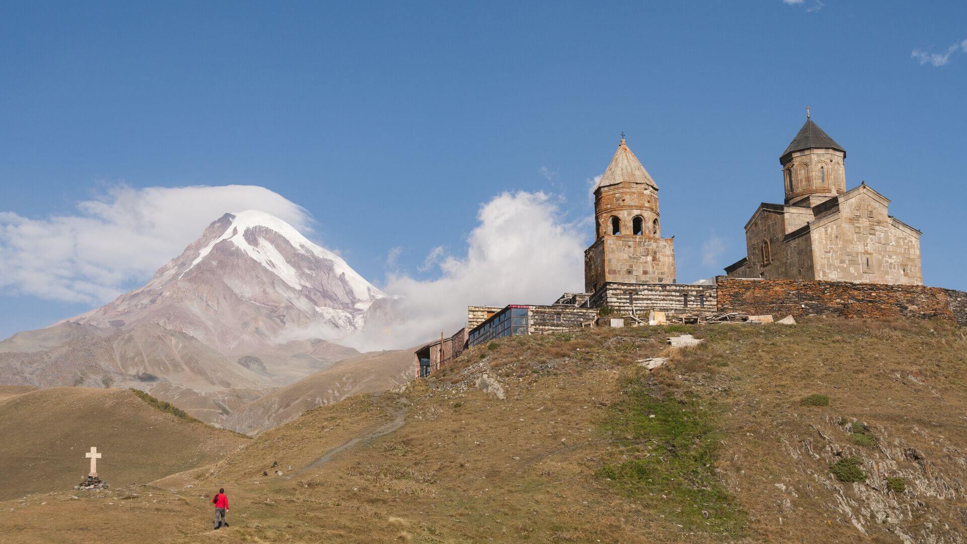 A man walks a road leading to the Tsmina Sameba Church, Georgia