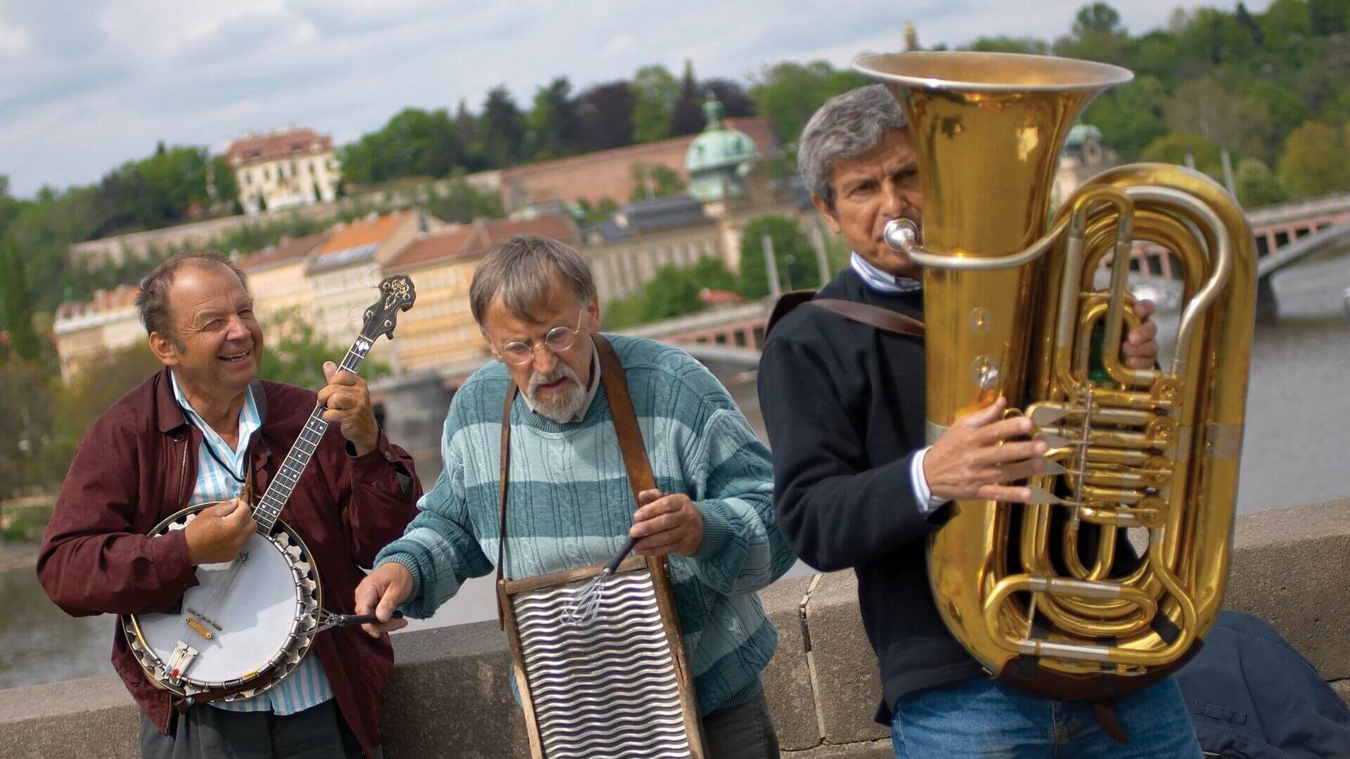 Three musicians play traditional instruments on a bridge, Czech Republic