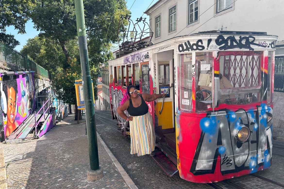 a Black woman smiling on a tram in Lisbon, Portugal