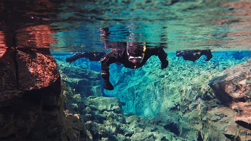 Snorkellers looking down at the Silfra Fissure