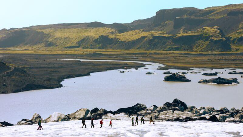 A group walking across the Sólheimajökull Glacier