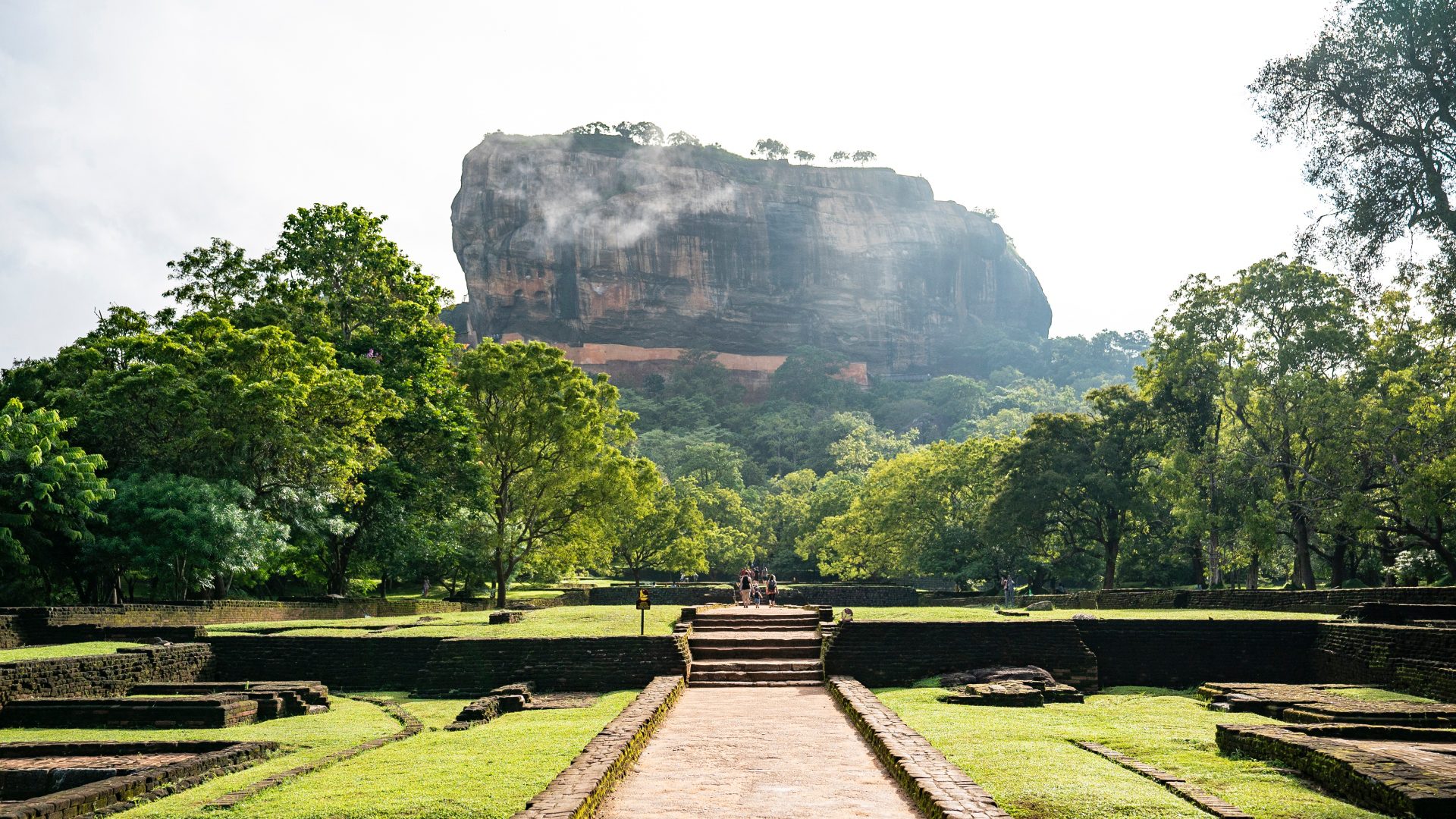 The imposing figure of Sigiriya surrounded by lush greenery. 
