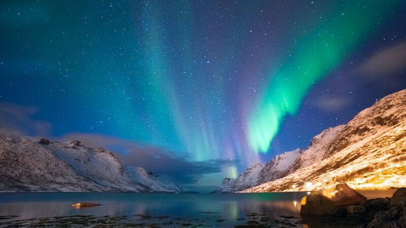 https://www.intrepidtravel.com/adventures/wp-content/uploads/2024/03/Intrepid-Travel-norway_northern-lights-mountains-aurora.jpg