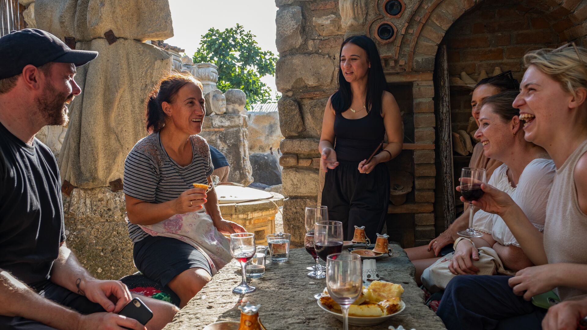 A group of travellers experiencing a traditional coffee cup reading in Albania