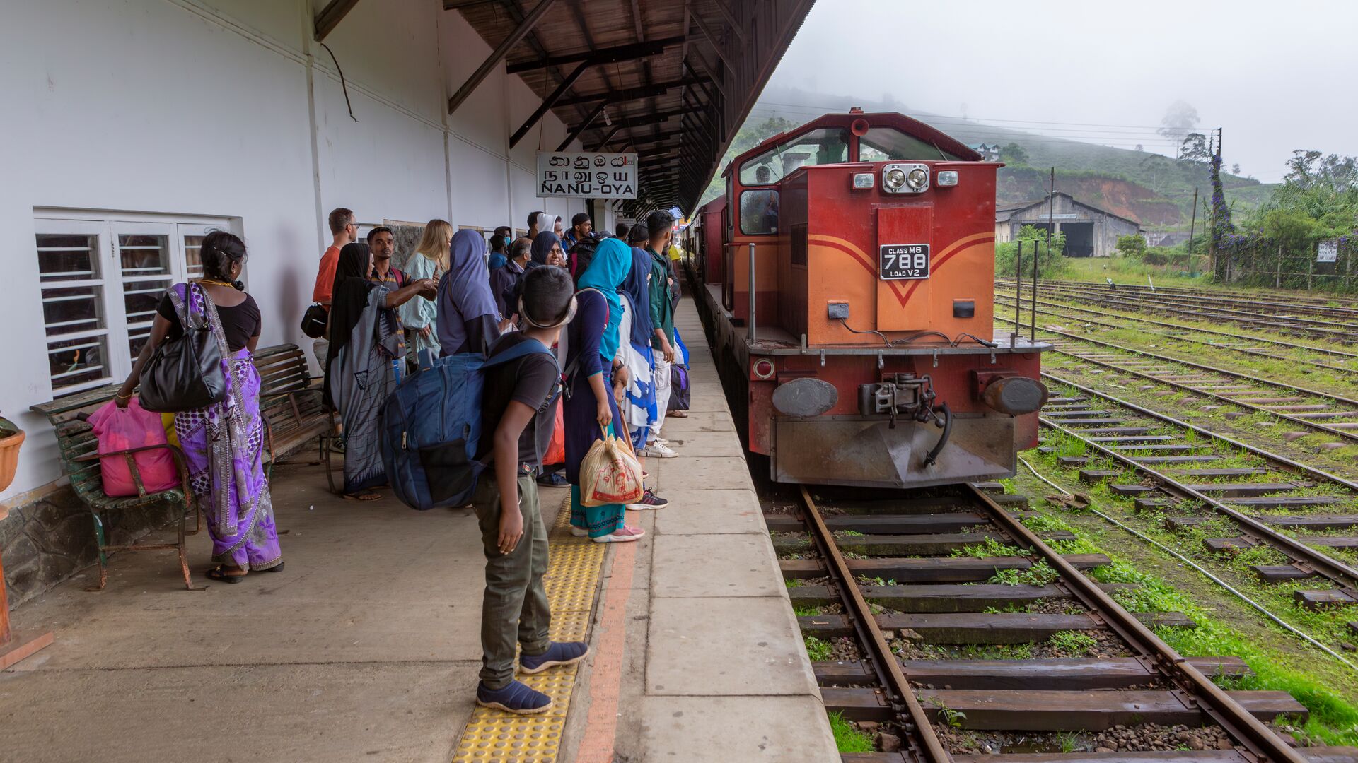 A crowd of passengers waiting to board a train in Sri Lanka