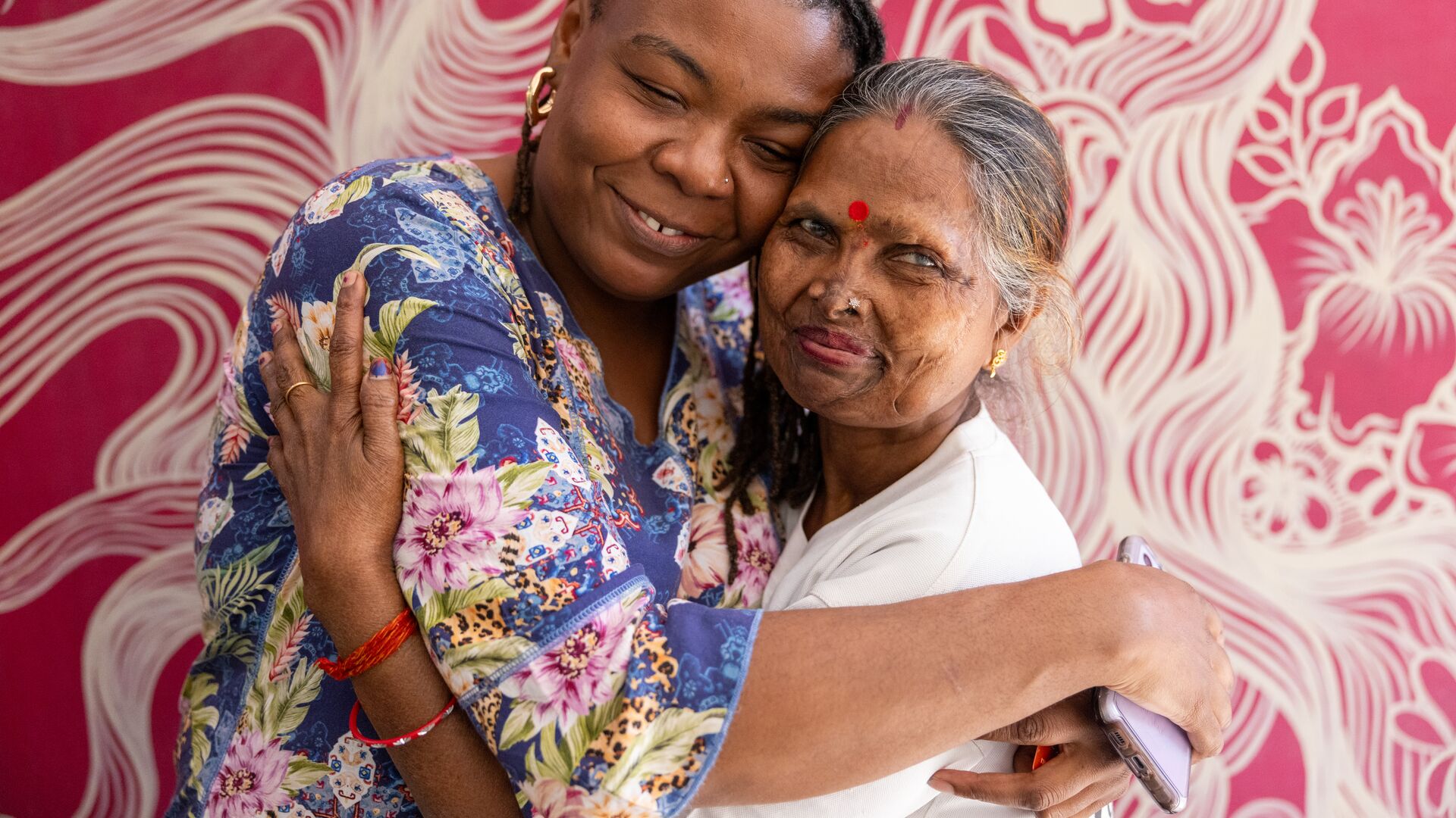 Wadzi and Geeta, an acid attack survivor, embrace at Sheroes Hangout Cafe, Agra, India