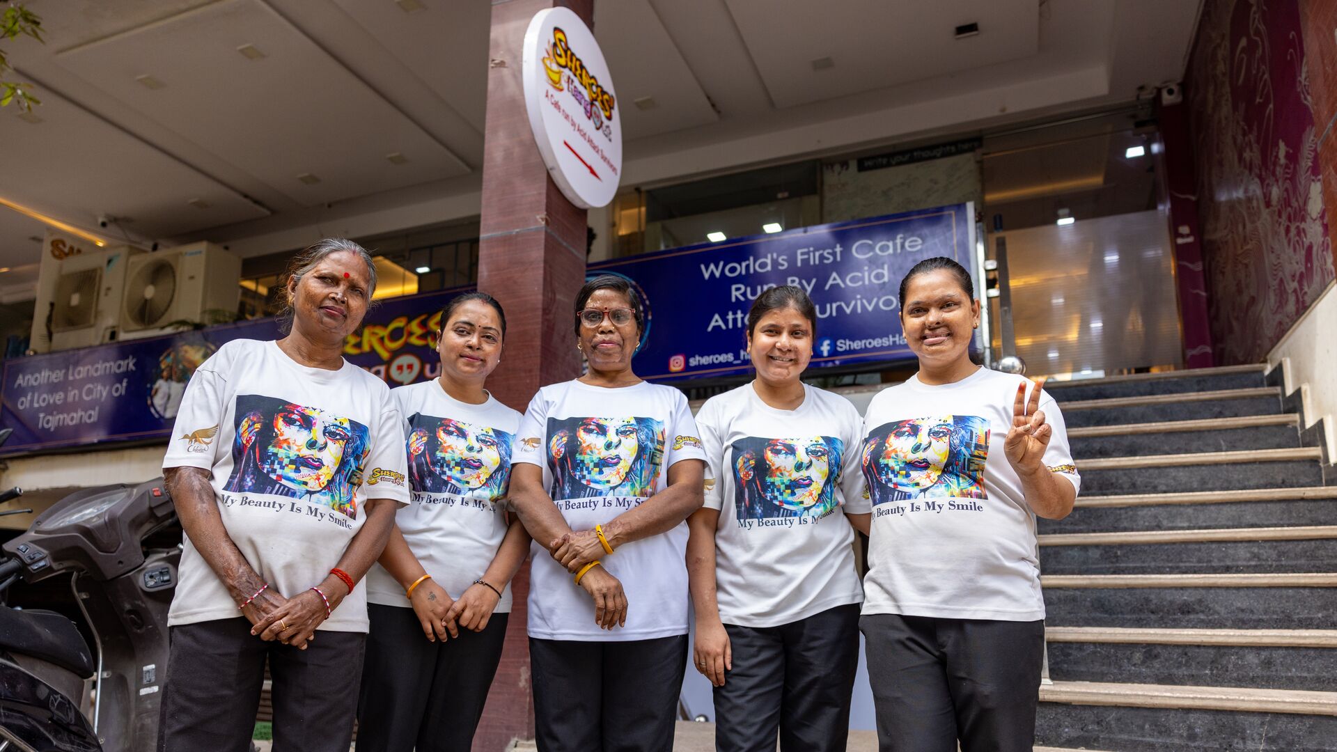 Geeta and four other sheroes pose in front of Sheroes Hangout Cafe, Agra, India