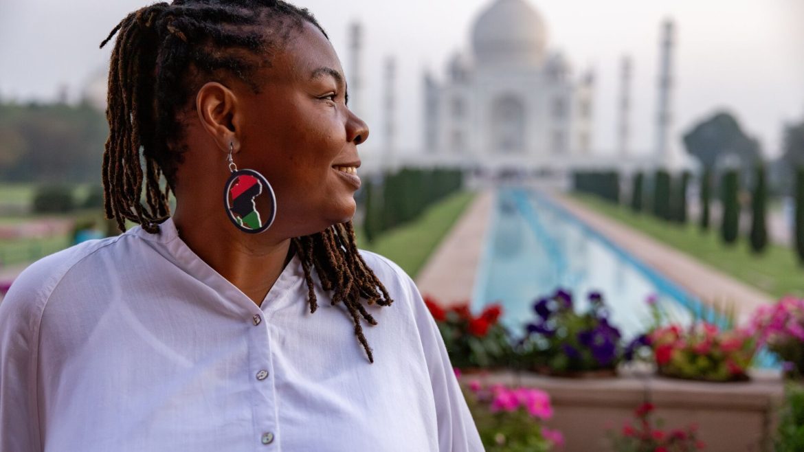 Author Wadzi smiles in front of the Taj Mahal, India