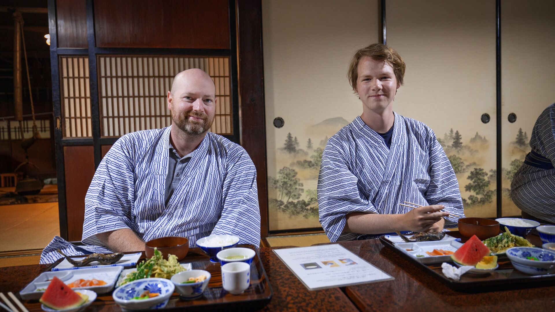 Two travellers enjoying a traditional meal in Japan