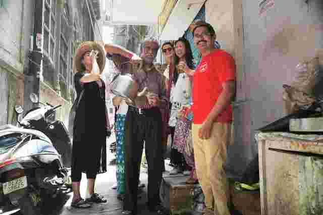 An Intrepid leader and a group of travellers drinking chai in a street