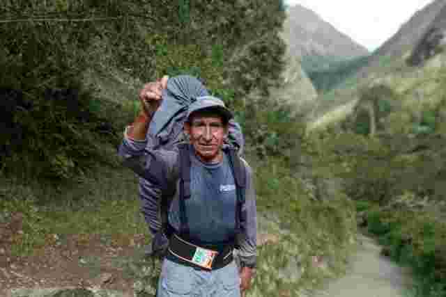 A local porter giving a thumbs up to the camera along the Inca Trail in Peru 