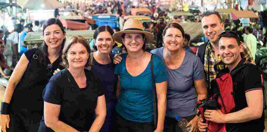 A group of travelers posing for a picture on their small group tour