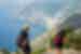 Two travellers hiking on the Path Of The Gods with a great view of the boats and village on Amalfi Coast