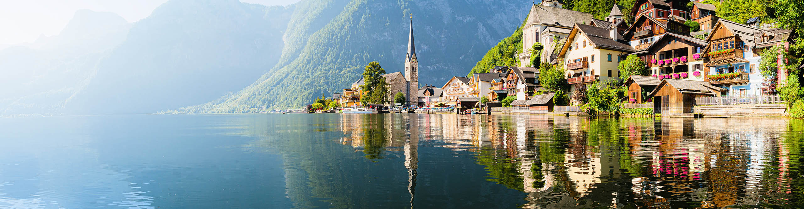 Best Austria Tours Vacations 2024 2025 Intrepid Travel US   Interpid Travel Austria Shutterstock 1688925418720 Scenic Panoramic View Of Famous Hallstatt Lakeside Town Reflecting In Lake In The Austrian Alps In Scenic Morning Light On A Beautiful Sunny Day In Summer Salzkammergut Region Austria 2560 