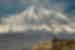 Wide view with Khor Virap Monastery buildings in foreground with Mount Ararat looming beyond
