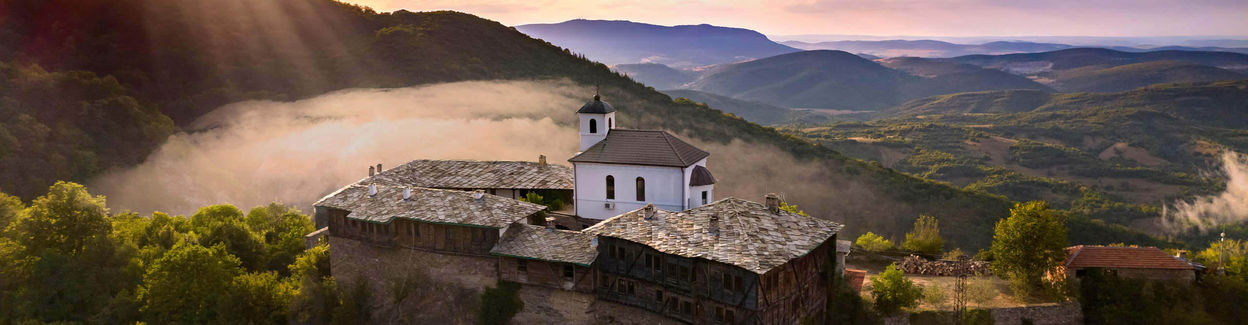 Best Bulgaria Tours Holidays 2024 2025 Intrepid Travel EU   Intrepid Travel Bulgaria GettyImages 1467871177 2560 Мysterious Landscape At SunsetAerial View Of Medieval Glozhene Monastery Of Saint George Lovech Region Bulgaria 