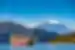 A bright red pirate ship sails on Lake Ashi with Mount Fujji behind