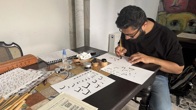 A man practising calligraphy