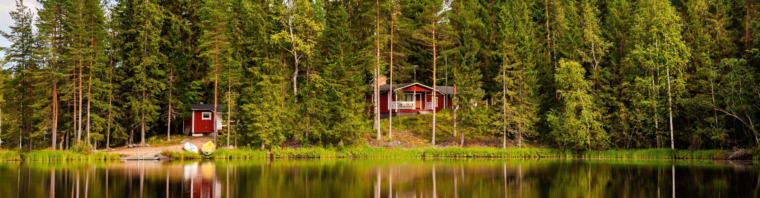 Best Finland Tours Holidays 2024 2025 Intrepid Travel AU   Intrepid Travel Shutterstock 501306640 2560 Red Wooden Cottage By The Lake In Rural FinlandRedWoodenCottageByTheLakeInRuralFinland 