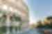 Iconic facade of Rome's Colosseum curves away from the camera with tiny crowds below for scale