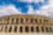 Travellers walk by the Roman ampitheatre Arena of Nimes in Provence France