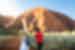 Intrepid travellers and leader approach the foot of Uluru for a talk